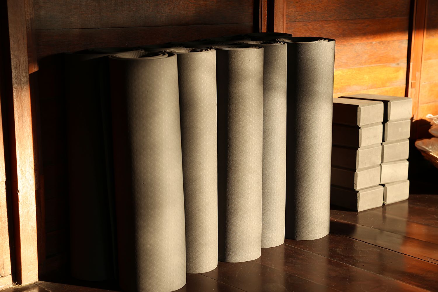 Rolled mats and blocks in the corner of the shala