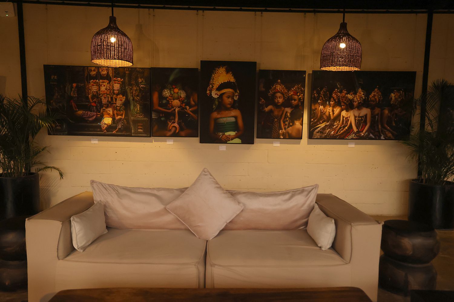 Photographs from the Ancient Songlines exhibition on the wall above a sofa in the lounge