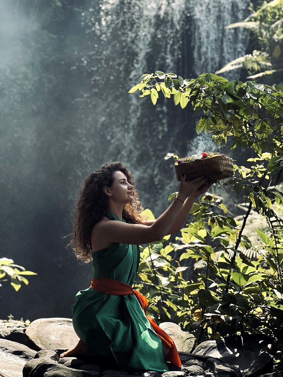 An offering held up towards the waterfall before the ritual